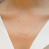 White gold chain necklace with ring clasp worn by model