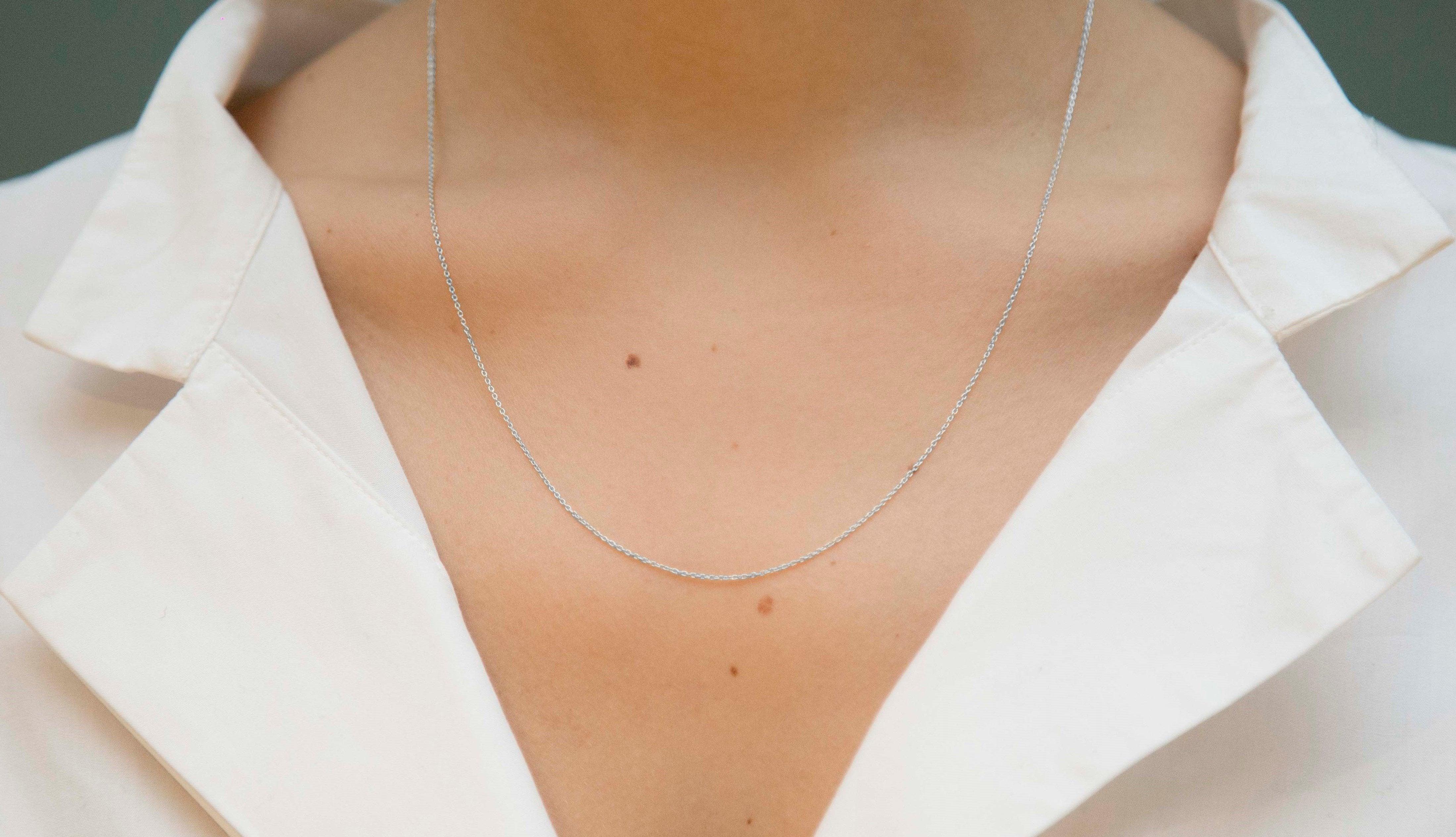 White gold chain necklace with ring clasp worn by model