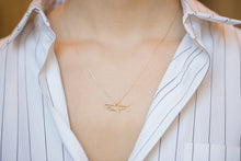 Load image into Gallery viewer, Gold chain necklace with shark shaped pendant worn by model

