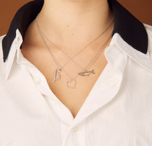 Load image into Gallery viewer, Model wearing White gold chain necklaces with dinosaur, heart, shark shaped pendants 
