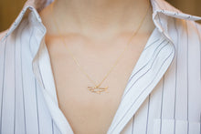 Load image into Gallery viewer, Gold chain necklace with shark shaped pendant and small diamond worn by model

