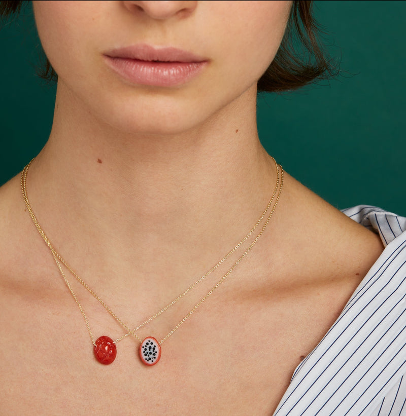 Gold chain necklaces with dragon fruit shaped coral worn by model