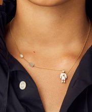 Load image into Gallery viewer, Gold chain necklace with astronaut shaped pendant and aquamarine stone and a pearl worn by model
