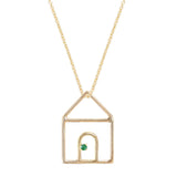 Gold chain necklace with house shaped pendant and small emerald