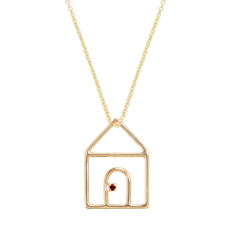 Gold chain necklace with house shaped pendant and small ruby
