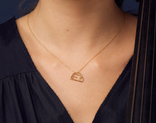 Load image into Gallery viewer, Gold chain necklace with igloo shaped pendant worn by model
