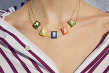 Load image into Gallery viewer, Gold chain necklace with multiple colored porcelai cameo pendants worn by model
