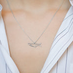 White gold chain necklace with shark shaped pendant worn by model