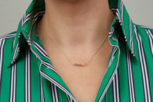Load image into Gallery viewer, Gold chain necklace with swimmer shaped pendant with blue striped enamel swimsuit worn by model
