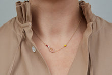 Load image into Gallery viewer, Gold chain necklace with gold tennis racquet and ball shaped pendants in pink and yellow enamel worn by model
