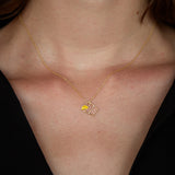 Gold chain necklace with tequila shot shaped pendant worn by model