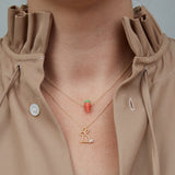 Gold chain necklacs with rabbit shaped pendant with pearl and coral carrot pendant worn by model