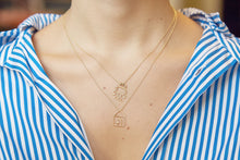 Load image into Gallery viewer, Gold chain necklace with robot shaped pendant and blue sapphires worn by model

