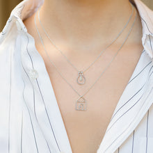 Load image into Gallery viewer, White gold chain necklace with house shaped pendant and small diamond worn by model
