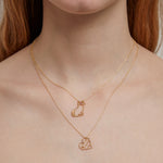 Woman wearing gold chain necklaces with gold pendants