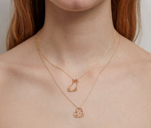 Load image into Gallery viewer, Woman wearing gold chain necklaces with gold pendants
