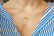 Load image into Gallery viewer, Woman wearing gold chain necklaces with small camera and rainbow shaped pendants with little stones
