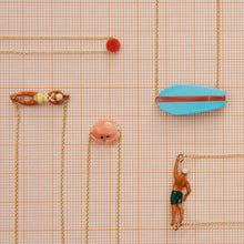 Load image into Gallery viewer, Jewelry composition with gold necklaces with surf, swimmer, crab shaped pendants

