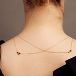 Gold rolo chain necklaces with a baguett cut stones on woman