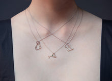 Carica l&#39;immagine nel visualizzatore di Gallery, Woman wearing three white gold necklaces with a two cat shaped pendants and a martini cocktail shaped pendant
