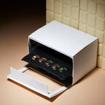 Miniature paper oven with small croissant shaped gold pendants