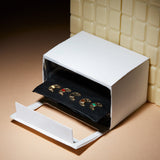 Miniature paper oven with small croissant shaped gold pendants