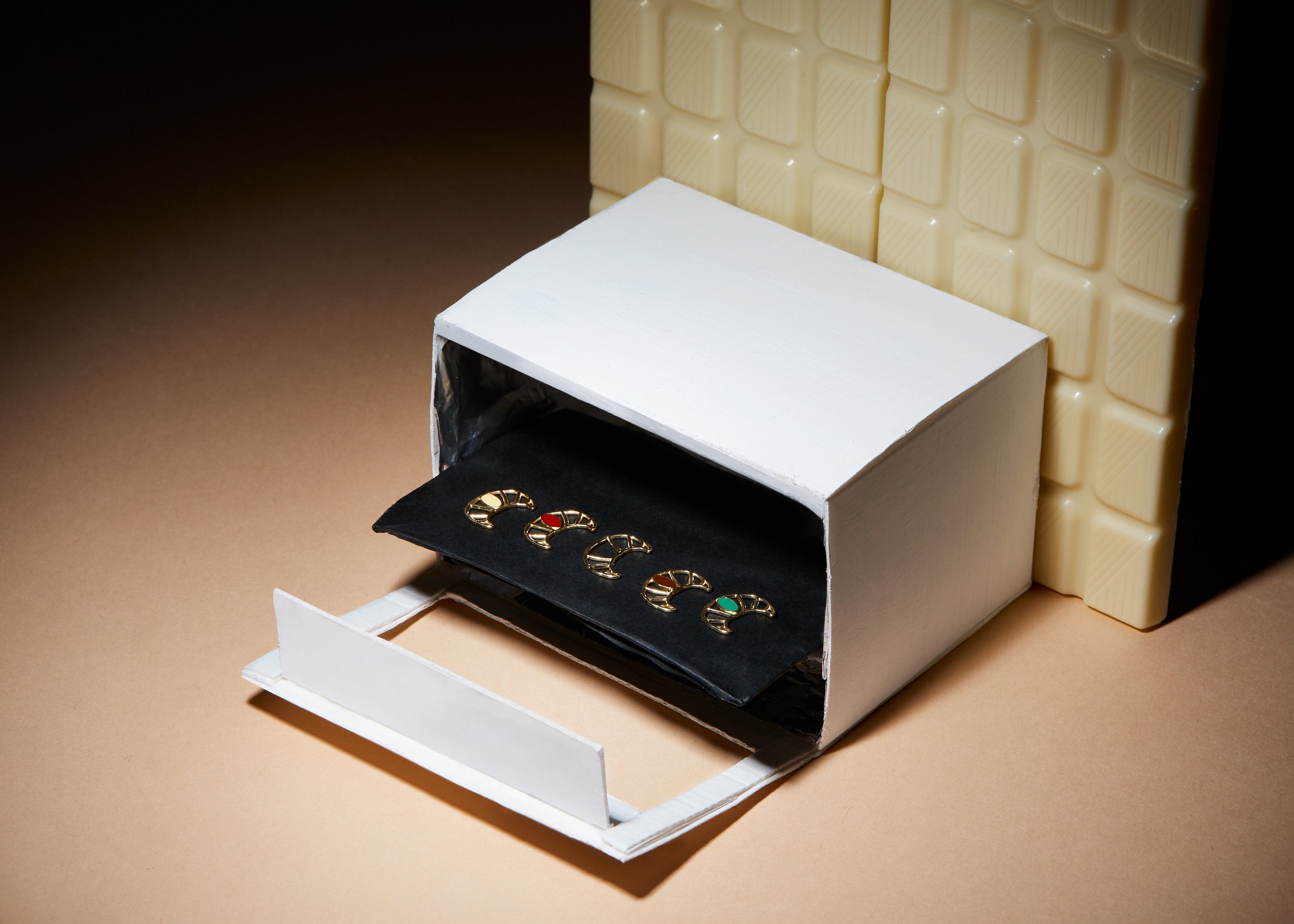 Miniature paper oven with small croissant shaped gold pendants