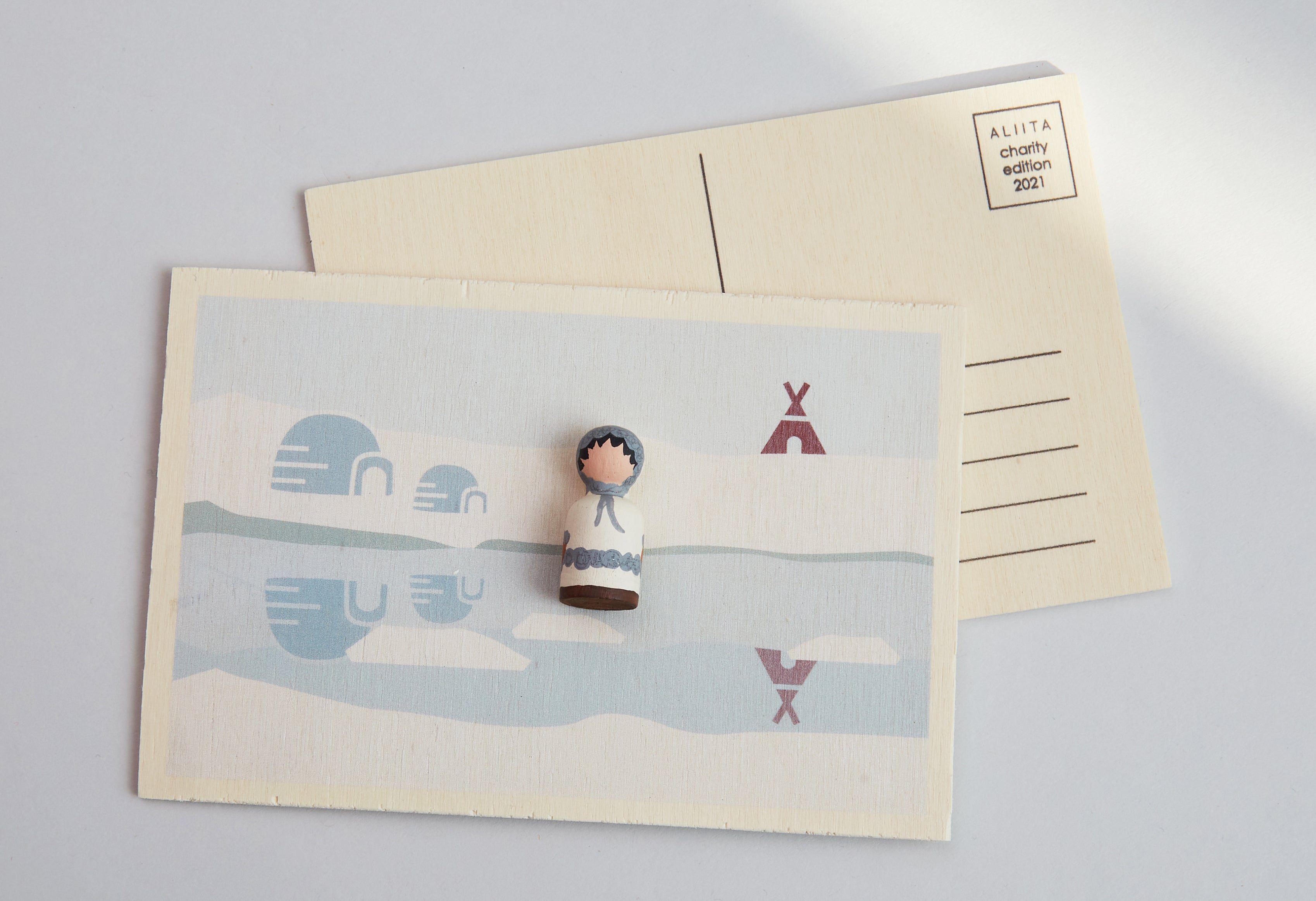 Wooden postcard with miniature eskimo
