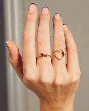 Load image into Gallery viewer, Hand wearing a heart shaped ring with a garnet baguette and a gold ring with baguette cut citrine and pink tourmaline

