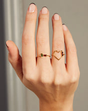 Load image into Gallery viewer, Hand wearing a heart shaped ring with a garnet baguette and a gold ring with baguette cut garnet and green tourmaline
