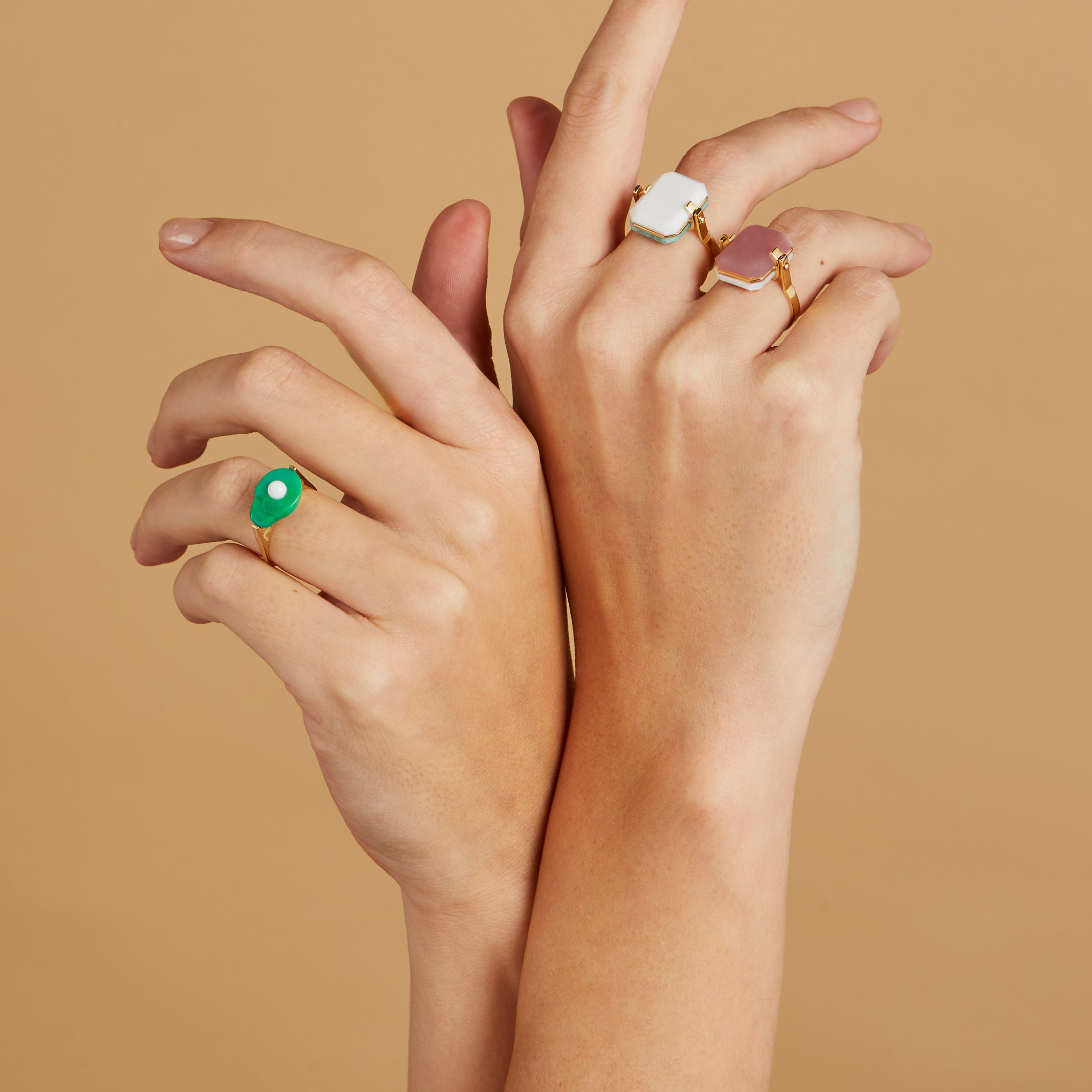 Gold rings with turquoise avocado and preciouse stones on model's hands
