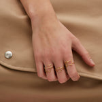 Gold shark shaped ring worn by model