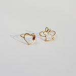 Gold rings shaped like a heart with a garnet baguette stone and a little rabbit