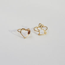 Load image into Gallery viewer, Gold rings shaped like a heart with a garnet baguette stone and a little rabbit
