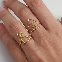 Load image into Gallery viewer, Woman wearing gold rings shaped like a little rabbit and a little house with ruby stone
