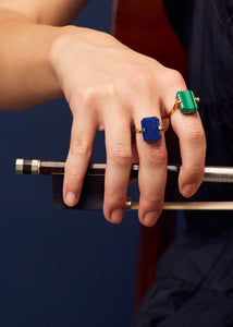 Gold rings with lapis lazuli and malachite worn by model