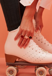 Woman wearing gold rings with rhombus cut stones