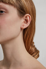 Load image into Gallery viewer, Model wearing a mini gold hoop earring
