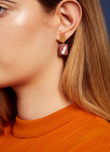 Load image into Gallery viewer, Woman wearing gold earrings with eggplant cameos made in porcelain
