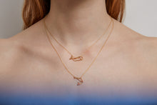 Load image into Gallery viewer, Woman wearing two gold necklaces with pendants shaped like a whale and a shrimp
