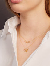 Load image into Gallery viewer, Woman wearing a gold necklace with a dragonfly shaped pendant and a gold necklace with a waterlily shaped pendant
